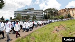 FILE - Health workers under the Kenya Medical Practitioners, Pharmacists and Dentists Union (KMPDU) demonstrate in Nairobi, Kenya, April 16, 2024.