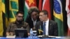 Barbados Prime Minister Mia Mottley, center, talks to Guyana's President Irfaan Ali, left, and Jamaica's Prime Minister Andrew Holness during an emergency Caribbean Community bloc meeting on Haiti in Kingston, Jamaica, on March 11, 2024.