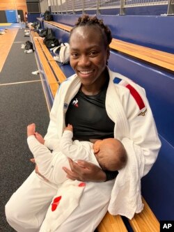 French world and Olympic judo champion Clarisse Agbegnenou breastfeeds her baby Athena at a gym in France on Oct. 17, 2022. Agbegnenou won a world title in May, 10 months after giving birth and while continuing to breastfeed her baby.