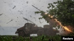 FILE - Ukrainian servicemen fire a BM-21 Grad multiple launch rocket system towards Russian troops near a front line, amid Russia's war on its neighbor, in Ukraine's Donetsk region, April 24, 2024.