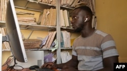 Dicakory Balde, a municipal official, works on the digital civil registry at the archive storage of the Parcelles Assainies town hall in Dakar, Senegal, July 19, 2024.