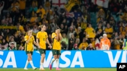 Australia's Caitlin Foord, Emily Van Egmond and Sam Kerr walk after the Women's World Cup semifinal soccer match between Australia and England at Stadium Australia in Sydney, Australia, Aug. 16, 2023.