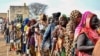 FILE - Women who fled the war-torn Sudan queue to receive food rations at the United Nations High Commissioner for Refugees (UNHCR) transit center in Renk, near the border crossing point in Renk County of Upper Nile State, South Sudan, May 1, 2023. 