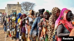 Women who fled the war-torn Sudan queue to receive food rations at the United Nations High Commissioner for Refugees transit center in Renk, near the border crossing point in Renk County of Upper Nile State, South Sudan May 1, 2023. 