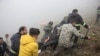 Rescue team members carry a body following a crash of a helicopter carrying Iran's President Ebrahim Raisi, in Varzaqan, East Azerbaijan Province, Iran, May 20, 2024. (WANA (West Asia News Agency))