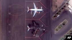 This satellite image provided by Maxar Technologies shows a destroyed Ukrainian airplane in Khartoum International Airport, Sudan, April 17, 2023.
