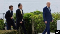 From left, France's President Emmanuel Macron, Japan's Prime Minister Fumio Kishida and US President Joe Biden walk before an economic security meeting during the G7 summit, at the Grand Prince Hotel in Hiroshima, Japan, May 20, 2023.