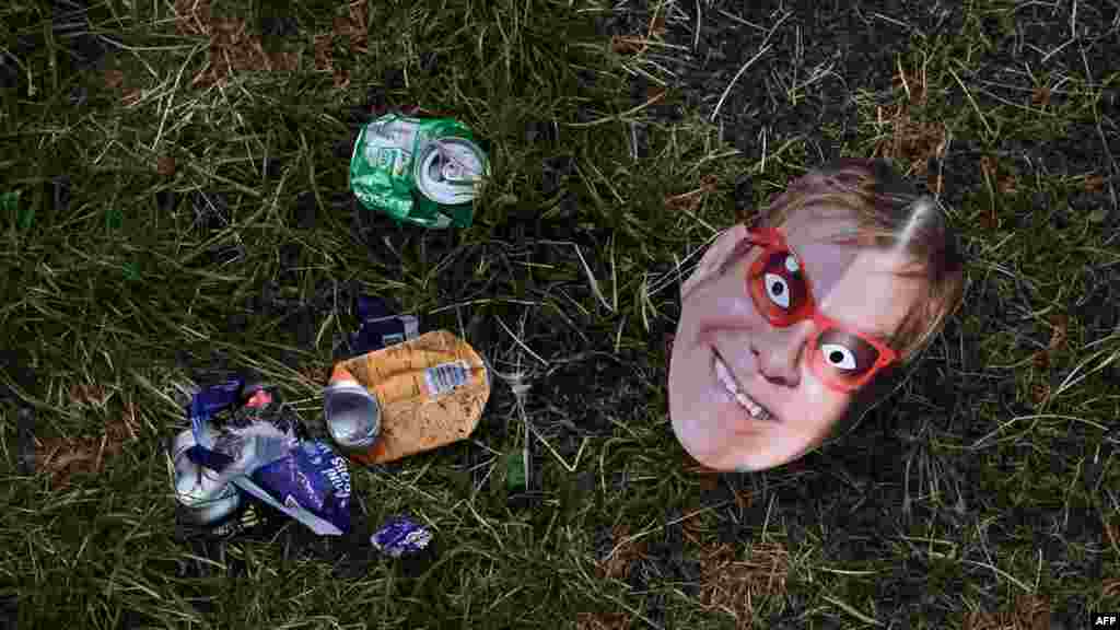 A photograph taken on June 26, 2023, shows a mask picturing British singer and musician Elton John and trash left behind on the ground at the end of the week-long Glastonbury Festival in the village of Pilton in Somerset, southwest England.