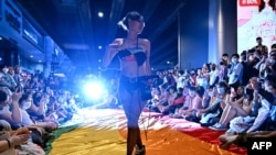 FILE - Members of SWING (Service Members in Group) Foundation, an organization for the empowerment of sex workers in Thailand, perform for members of the LGBTQIA+ community and allies during Pride March in Bangkok on June 5, 2022.