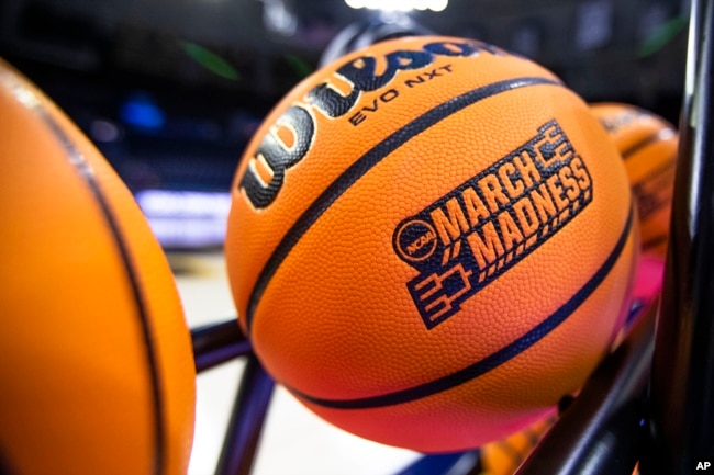 FILE - A basketball with a March Madness logo rests on a rack before a First Four game between Illinois and Mississippi State in the NCAA women's basketball tournament Wednesday, March 15, 2023, in South Bend, Ind. (AP Photo/Michael Caterina)