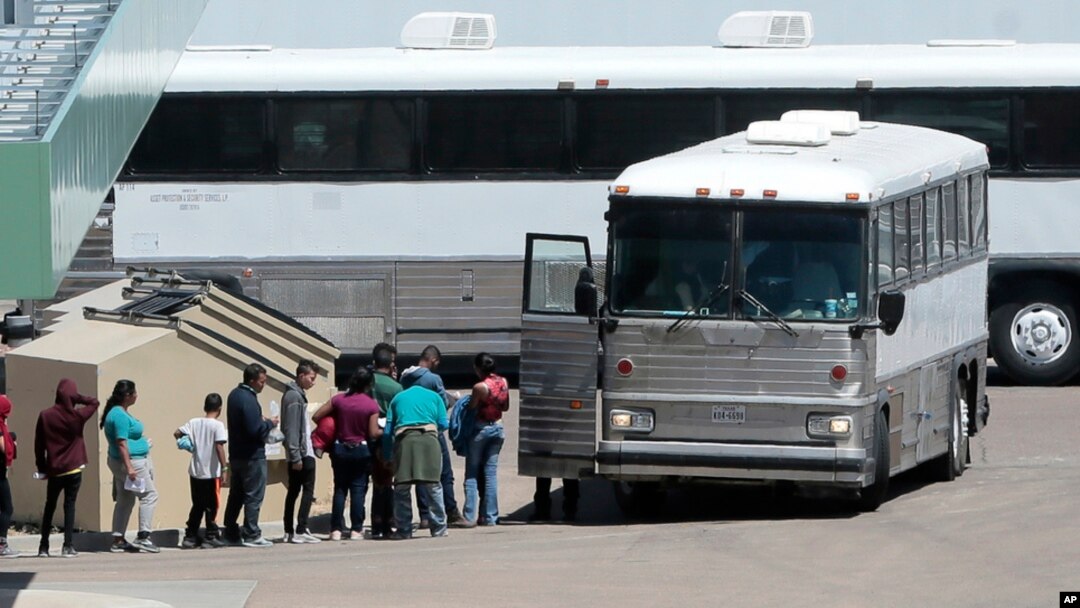FILE - In this April 20, 2019, photo, migrants are loaded onto a bus at the Border Patrol headquarters on Hondo Pass, in El Paso, Texas. 