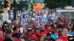 FILE - United Auto Workers members march through downtown Detroit, Sept. 15, 2023. The UAW is conducting a strike against Ford, Stellantis and General Motors.