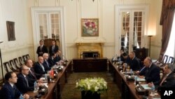 Egyptian Foreign Minister Sameh Shoukry, second right, meets with his Turkish counterpart Mevlut Cavusoglu, third left, and his delegations at Tahrir Palace in Cairo, March 18, 2023.