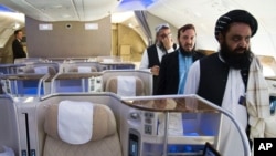 FILE - Badruddin Haqqani, right, then the Afghan Taliban envoy to the United Arab Emirates, walks through an aircraft displayed at the Dubai Air Show in the UAE, Nov. 13, 2023. The UAE on Aug. 21, 2024, accepted Haqqani's credentials as ambassador.