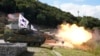 FILE - A South Korean Army K2 tank fires during a live-fire demonstration as part of Defense Expo Korea at a training ground in Pocheon, South Korea, Sept. 20, 2022.