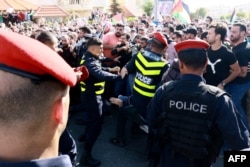 Protesters scuffle with Jordanian police near the Israeli Embassy in Amman, Jordan, Oct. 18, 2023, as they demonstrate against a strike on a hospital in the Gaza Strip.