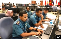 FILE - Indonesian navy staff participate in a computer-simulated drill in Singapore, Aug. 3, 2018. Chinese and Southeast Asian naval forces staged such drills so they can jointly respond to emergencies and build trust.