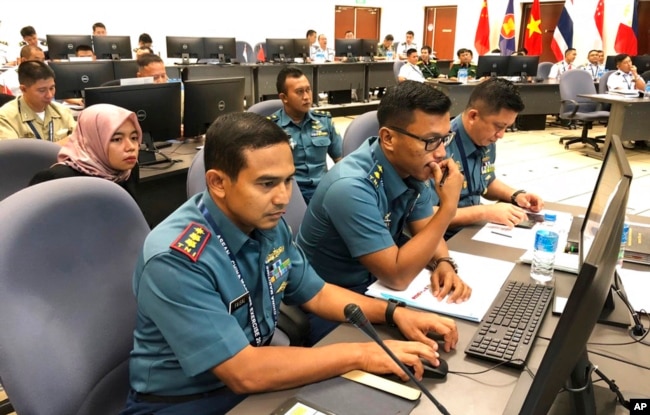 FILE - Indonesian navy staff participate in a computer-simulated drill in Singapore, Aug. 3, 2018. Chinese and Southeast Asian naval forces staged such drills so they can jointly respond to emergencies and build trust.