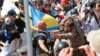 FILE - White nationalists clash with counterdemonstrators at the entrance to Lee Park in Charlottesville, Va., Aug. 12, 2017. Robert Rundo, leader of a Southern California white supremacist group, was among those arrested in connection with the incident.