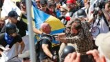 FILE - White nationalists clash with counterdemonstrators at the entrance to Lee Park in Charlottesville, Va., Aug. 12, 2017. Robert Rundo, leader of a Southern California white supremacist group, was among those arrested in connection with the incident.