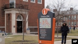 FILE - In this Jan. 27, 2017, photo, a student goes about his day on the Buffalo State College campus in Buffalo, NY. 