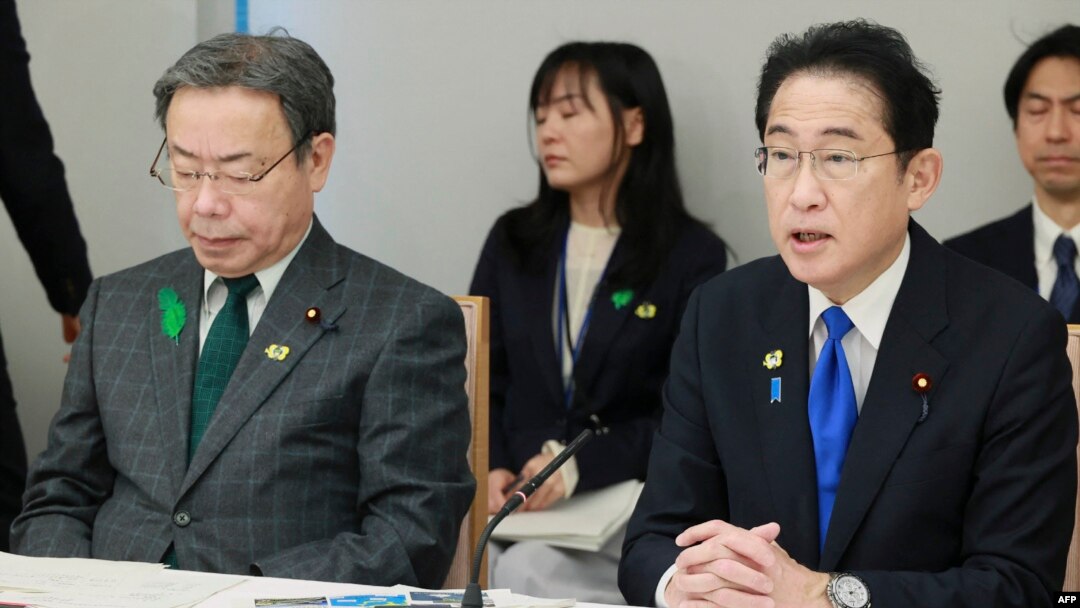 Japan's Prime Minister Fumio Kishida, right, speaks next to Minister of State for Ocean Policy Koichi Tani during a meeting at the prime minister's office in Tokyo, April 28, 2023.