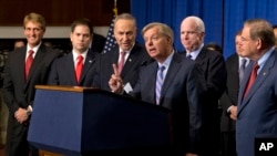 FILE - Sen. Lindsey Graham, center, speaks of immigration reform legislation outlined by the Senate's bipartisan "Gang of Eight" to create a path for unauthorized immigrants to apply for U.S. citizenship, April 18, 2013, in Washington.