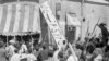 FILE - A crowd of demonstrators tears down the Iran Party's sign from the front of the headquarters in Tehran on Aug. 19, 1953, during the CIA-backed coup that ousted Prime Minister Mohammad Mossadegh and his government. 