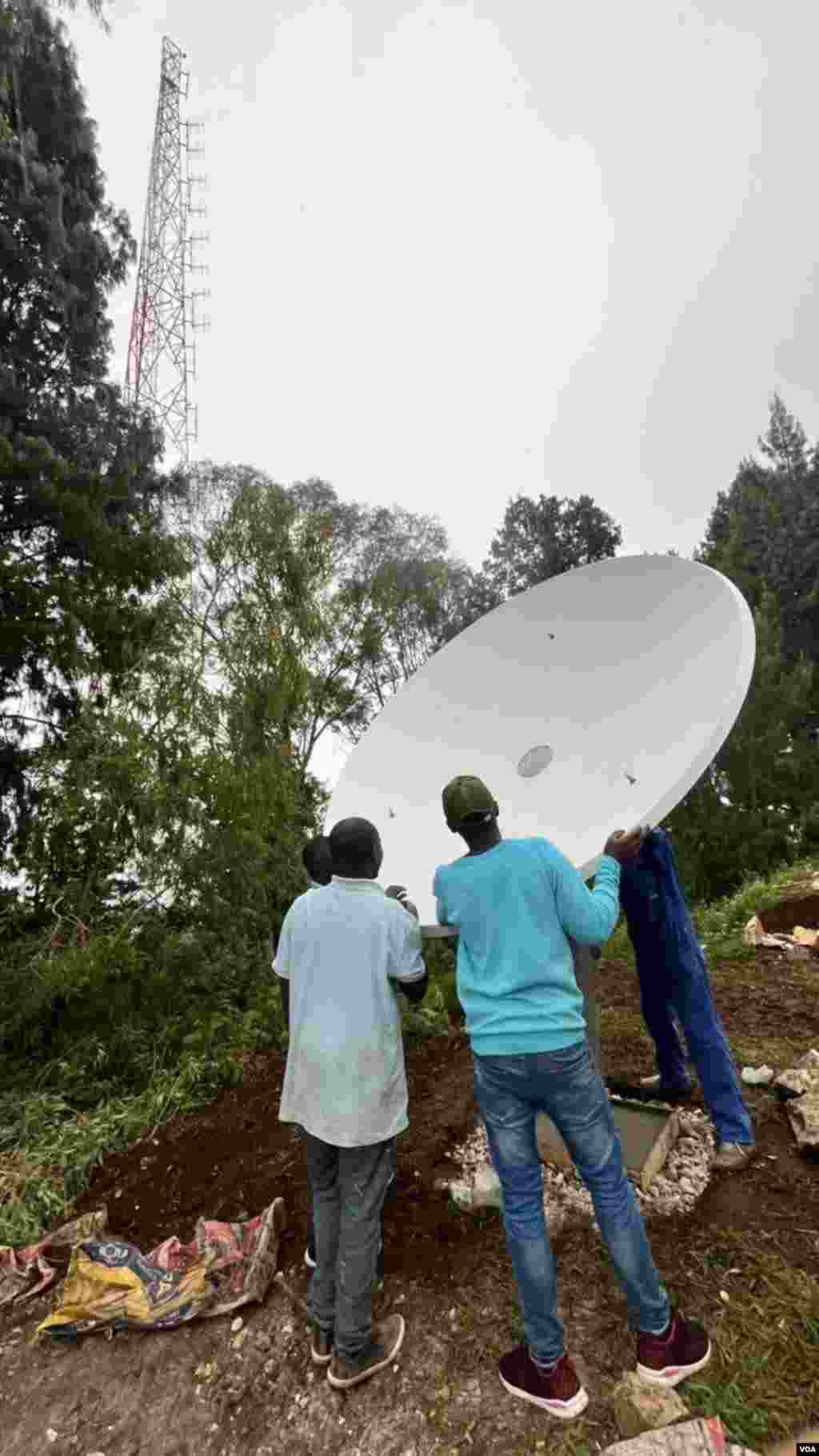 Technicians in Karongi, Rwanda bring equipment to broadcast tower that is home to the Voice of America’s new FM station, FM 93.3.