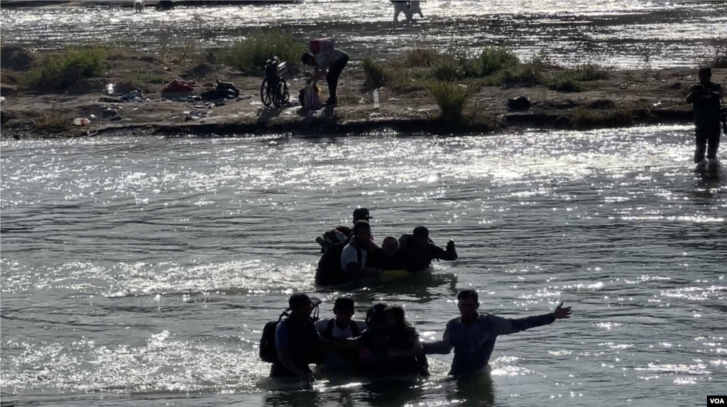 Mientras tanto, del lado mexicano del río Grande, las personas se reúnen en grupos para ayudarse a pasar en medio de la fuerte corriente para después entregarse a las autoridades fronterizas.&nbsp;