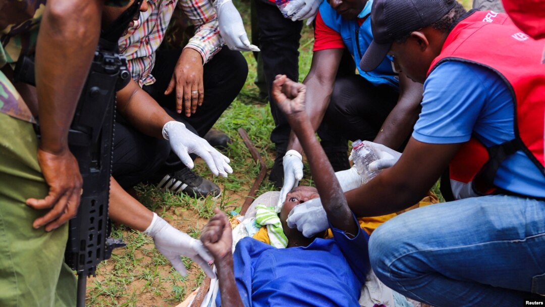 Members of the Kenya Red Cross and police officers attend to an emaciated member of a Christian cult named the Good News International Church in Shakahola forest of Kilifi county, Kenya, April 23, 2023.