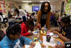 Roni Ramos and Sara Neal teach math at Whitehall Elementary School, Tuesday, Jan. 24, 2023, in Bowie, Md.