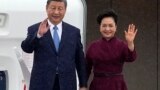 China's President Xi Jinping and his wife Peng Liyuan wave upon their arrival for an official two-day state visit at Orly airport, south of Paris on May 5, 2024. 