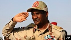 FILE - Gen. Mohammed Hamdan Dagalo, then deputy head of the military council, salutes during a rally, in Galawee, northern Sudan, June 15, 2019.