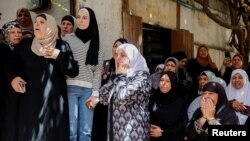 Mourners react during a funeral of Palestinian man Saleh Sabra, who was killed in an Israeli raid, in Askar Camp in Nablus, in the Israeli-occupied West Bank, May 15, 2023. 