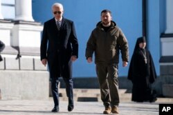 US President Joe Biden, left, walks with Ukrainian President Volodymyr Zelenskyy at St. Michael's Golden-Domed Cathedral during an unannounced visit, in Kyiv, Ukraine, Monday, Feb. 20, 2023. (AP Photo/Evan Vucci)