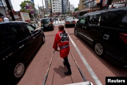 Rickshaw puller Misato Otoshi, 30, drives a rickshaw around Asakusa district in Tokyo, Japan, June 21, 2023.