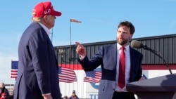 FILE - Sen. J.D. Vance, right, points toward Republican presidential candidate former President Donald Trump at a campaign rally, March 16, 2024, in Vandalia, Ohio. Trump on Monday picked Vance as his running mate.