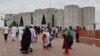 People gather outside the parliament building, a day after the resignation of Bangladeshi Prime Minister Sheikh Hasina, in Dhaka, Bangladesh, Aug. 6, 2024.