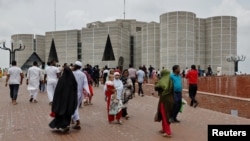 People gather outside the parliament building, a day after the resignation of Bangladeshi Prime Minister Sheikh Hasina, in Dhaka, Bangladesh, Aug. 6, 2024.