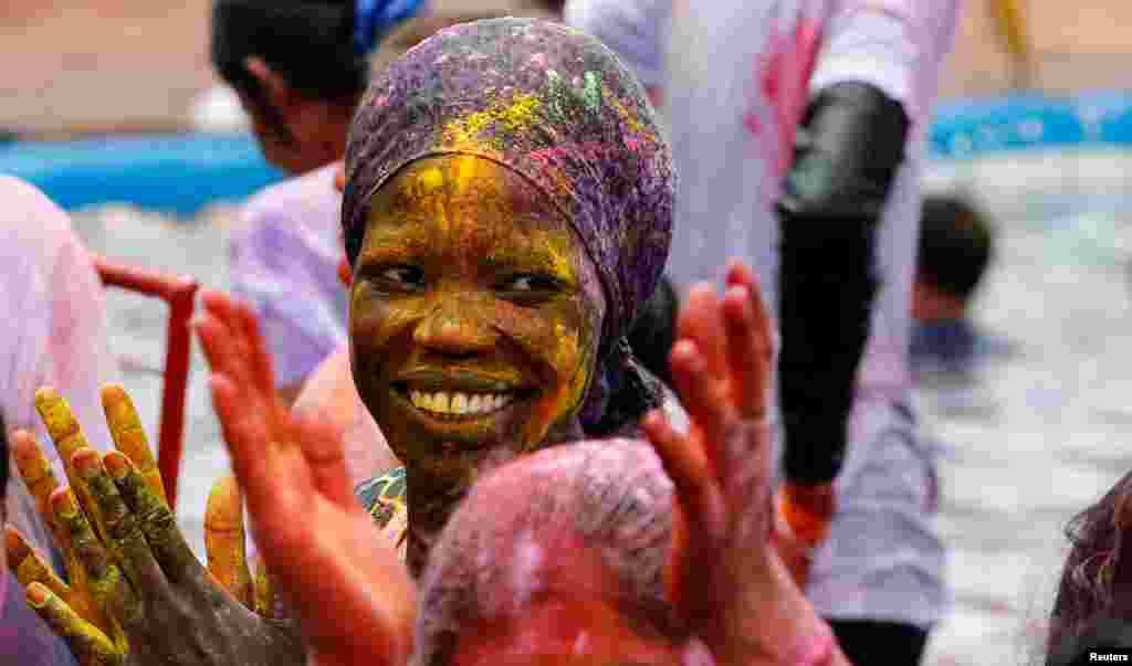 A woman daubed with color powders takes part in the Hindu Holi Festival celebrated as the Festival of Colors, Love, and Spring in Nairobi, Kenya.