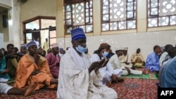 FILE - Muslim perform Eid Al-Fitr prayers, that marks the end of the Holy month of Ramadan, at the Tsinga Mosque in Yaounde, May 2, 2022. 