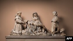 This handout photo obtained courtesy of the Metropolitan Museum of Art in New York (MET) on Feb. 18, 2023, shows the sculpture Pieta with Donors, Pons de Gontaut and his brother Armand, Bishop of Sarlat, created in Biron, Dordogne, France, around 1515.