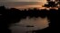 FILE - A small boat crosses the Acre River near the Chico Mendes Extractive Reserve, in Xapuri, Acre state, in Brazil's Amazon rainforest, Dec. 7, 2022.
