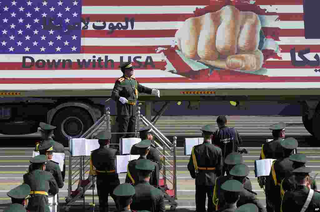 An anti-U.S. banner is carried on a truck in an annual military parade marking the anniversary of the beginning of war against Iran by former Iraqi Dictator Saddam Hussein, in front of the shrine of the late revolutionary founder Ayatollah Khomeini, just outside Tehran, Iran.