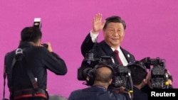 President of China Xi Jinping waves during the opening ceremony of the Asian Games, Hangzhou Olympic Sports Center Stadium, Sept. 23, 2023. 