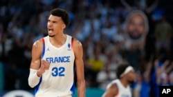 Victor Wembanyama of France celebrates after scoring a basket against United States during a men's gold medal basketball game at Bercy Arena, Aug. 10, 2024, in Paris