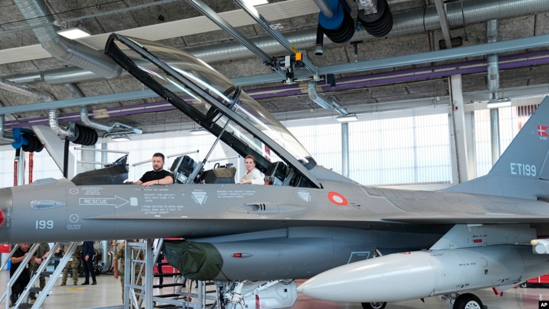 Ukrainian President Volodymyr Zelenskyy, left, and Denmark's Prime Minister Mette Frederiksen sit in a F-16 fighter jet at Skrydstrup Airbase, in Vojens, Denmark, Aug. 20, 2023.
