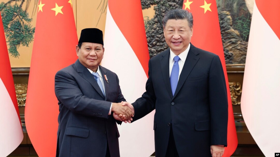 Chinese President Xi Jinping, at right, shakes hands with Indonesian President-elect Prabowo Subianto at the Great Hall of the People in Beijing on April 1, 2024, in this photo released by Xinhua News Agency.