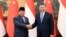 Chinese President Xi Jinping, at right, shakes hands with Indonesian President-elect Prabowo Subianto at the Great Hall of the People in Beijing on April 1, 2024, in this photo released by Xinhua News Agency.